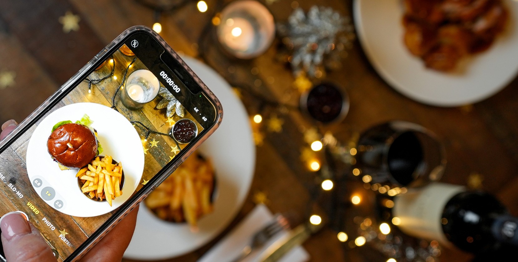A top-down photo being taken of a burger and fries.