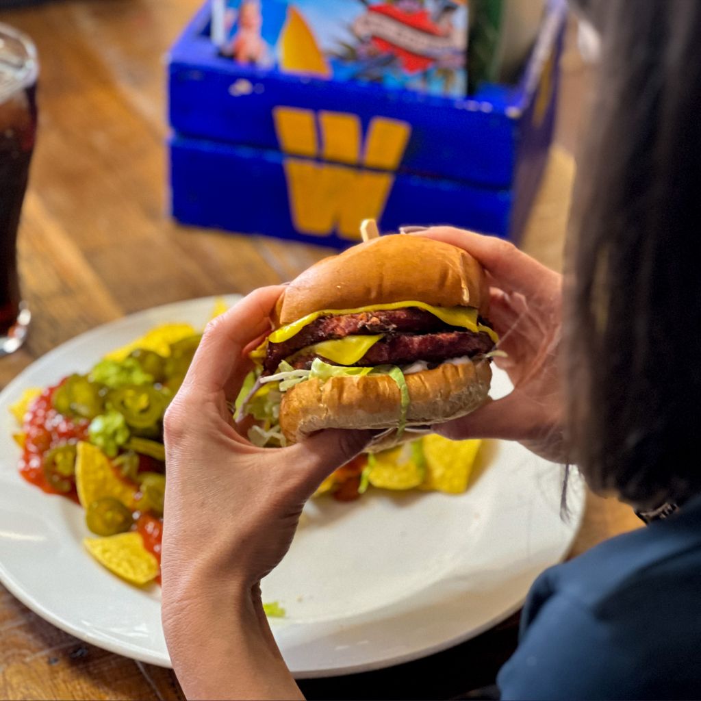 Someone about to tuck into a juicy burger at Walkabout.