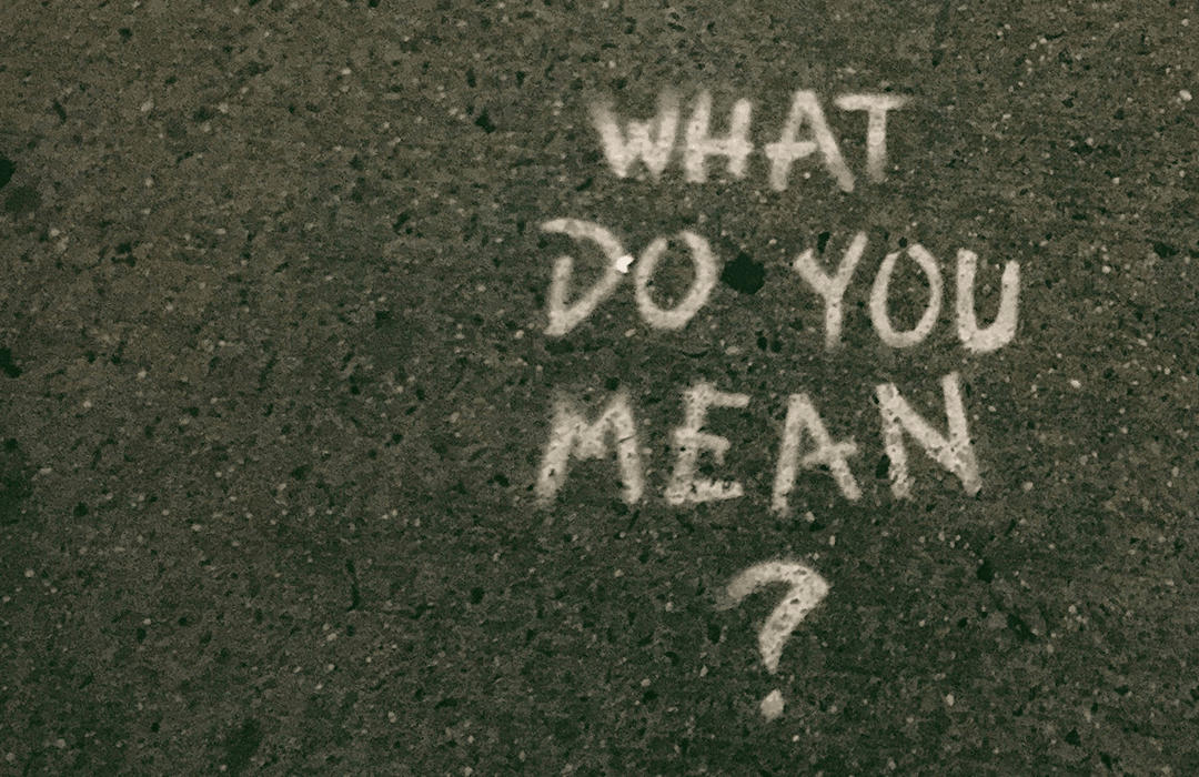 “What do you mean?” spray-painted onto concrete.
