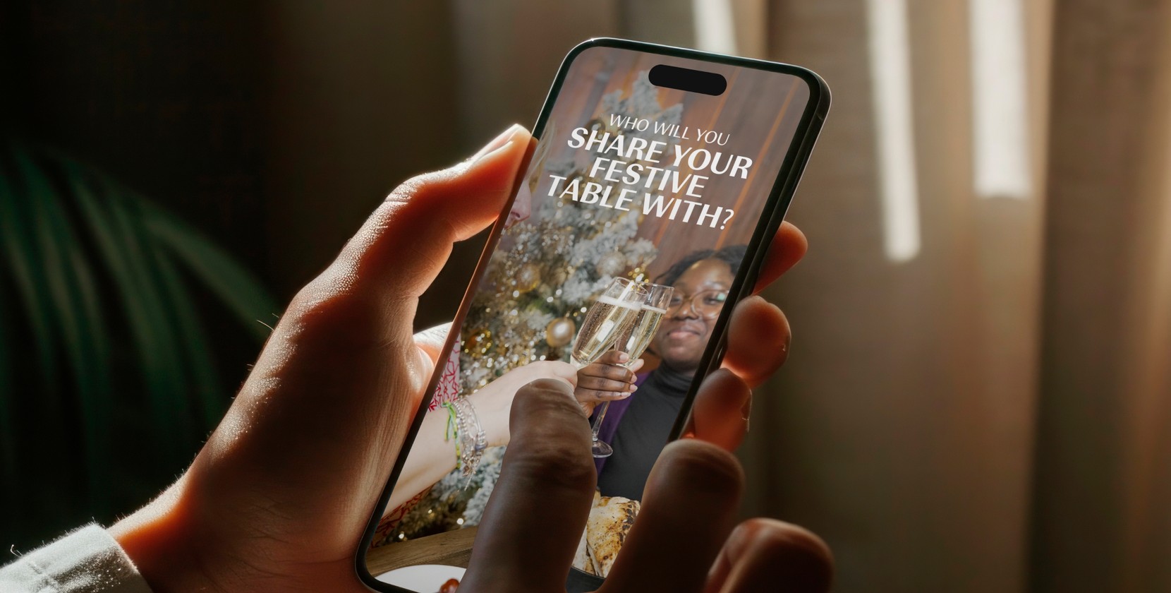 “Who will you share your festive table with?” on an iPhone screen.