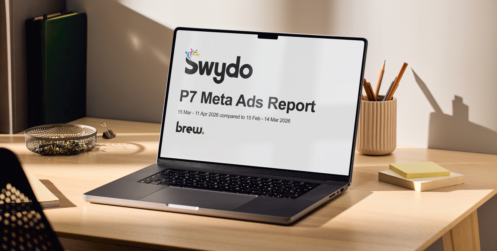A laptop showing a Swydo Meta ads report.