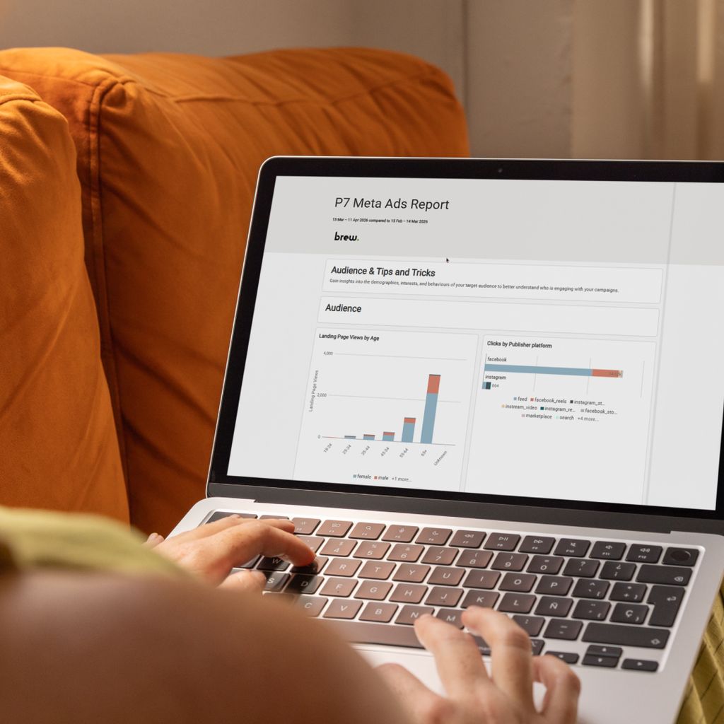 A person using a laptop to look through a Swydo Meta ads report. 