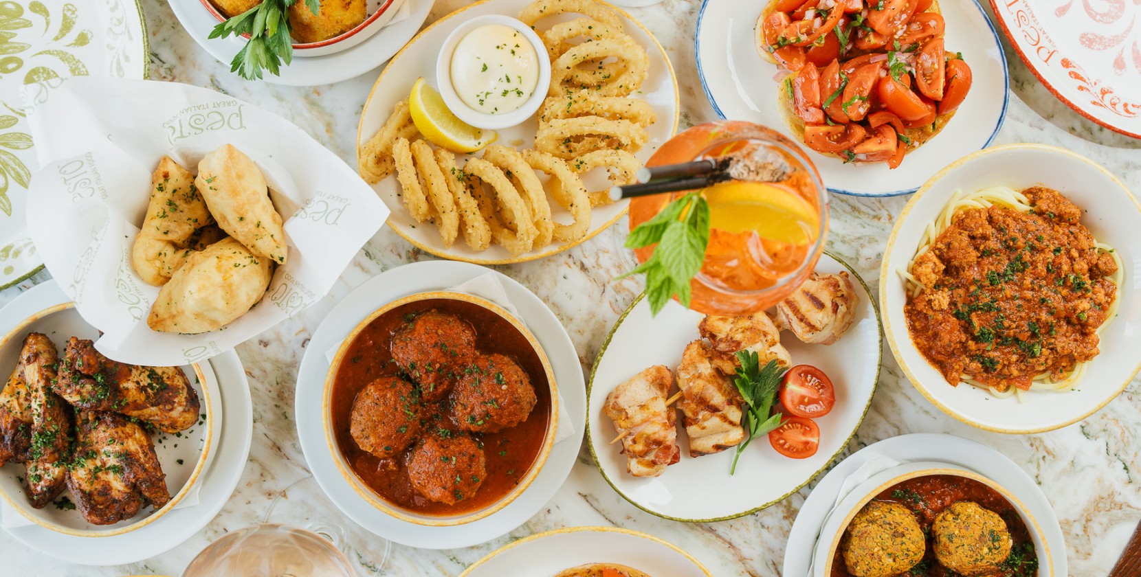 Flat-lay style photo of a table full of food and drink at a Pesto restaurant social media content shoot.