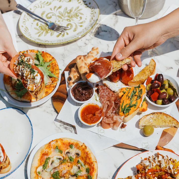 A sunny, flat-lay photo of a table full of food during the Pesto restaurant social media content day.