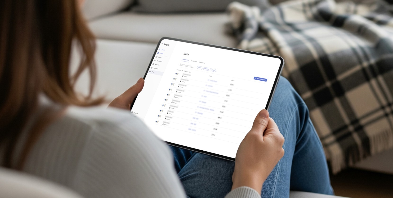 A woman using a tablet to look through files and reports. 