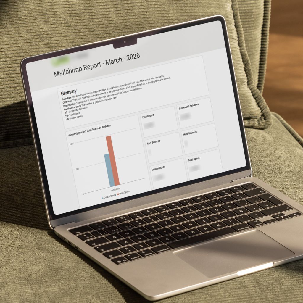 A laptop on a sofa, displaying a Mailchimp email marketing report.