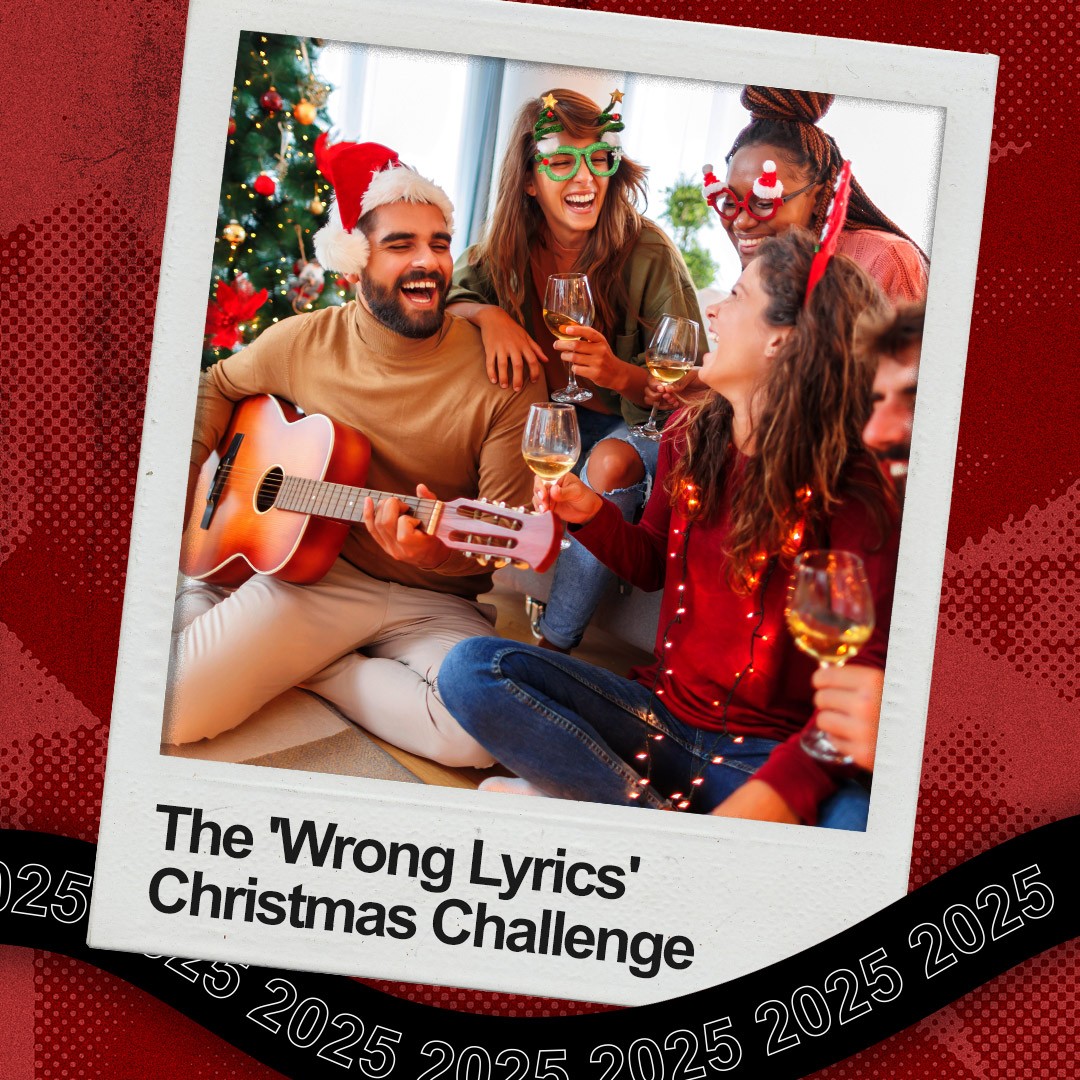 A family laughing while singing Christmas songs; a man holds an acoustic guitar. 