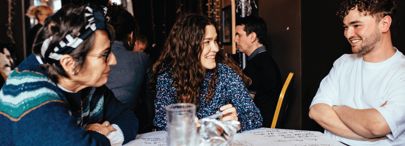 A group of Brew social media marketeers brainstorm around a table.
