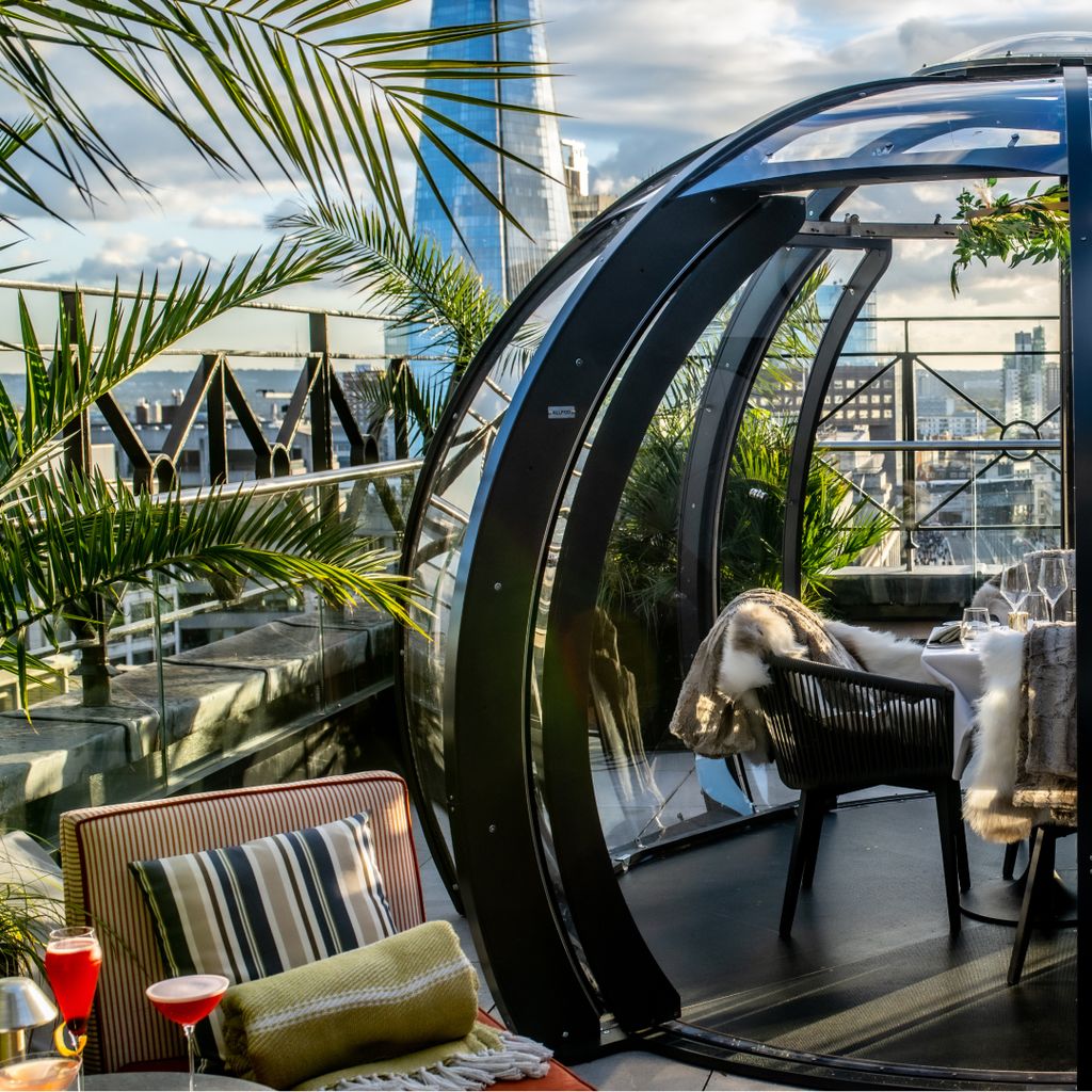 A stunning glass dome dining area with the London Shard in the background.